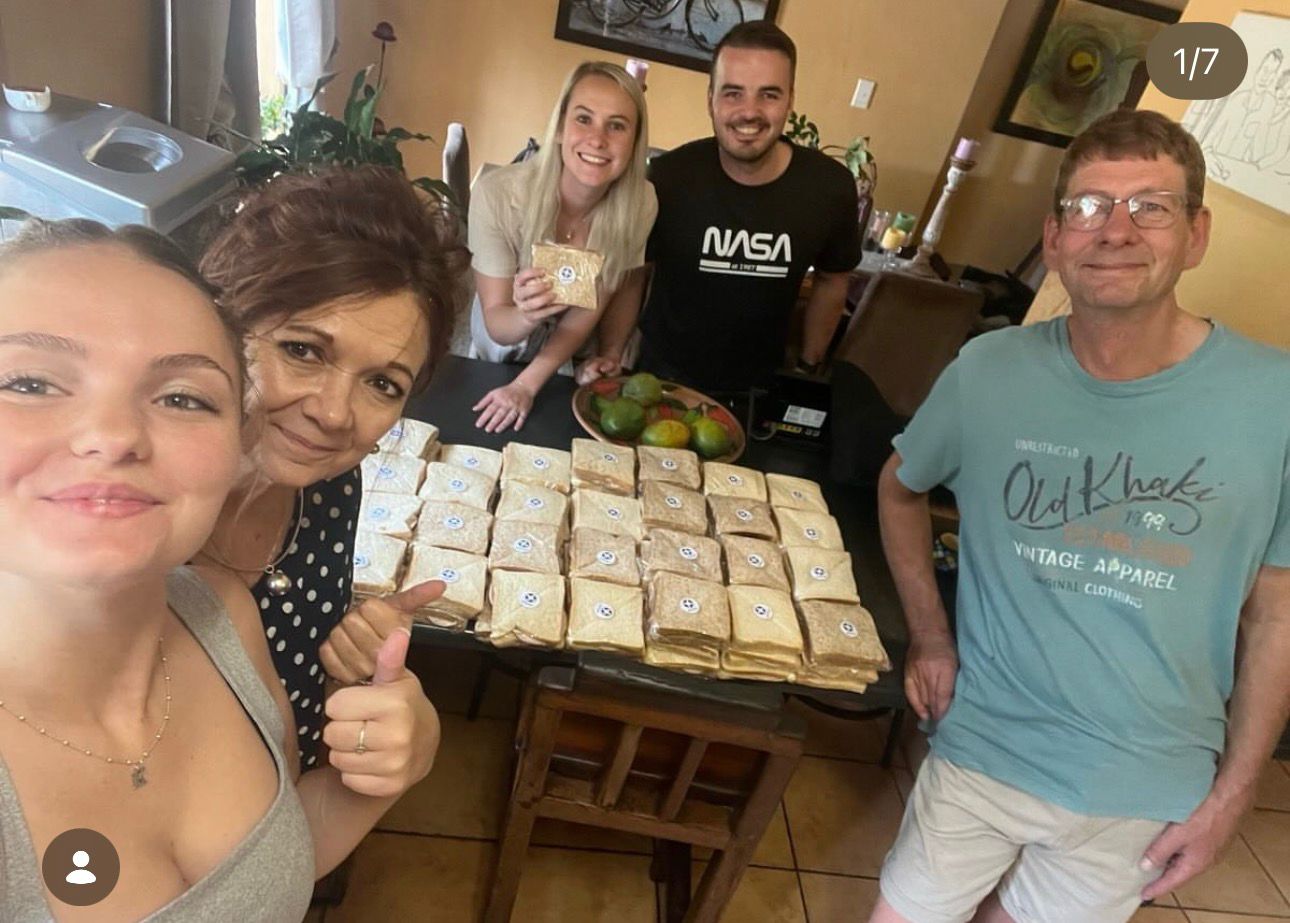 Family volunteers packing sandwiches together at home